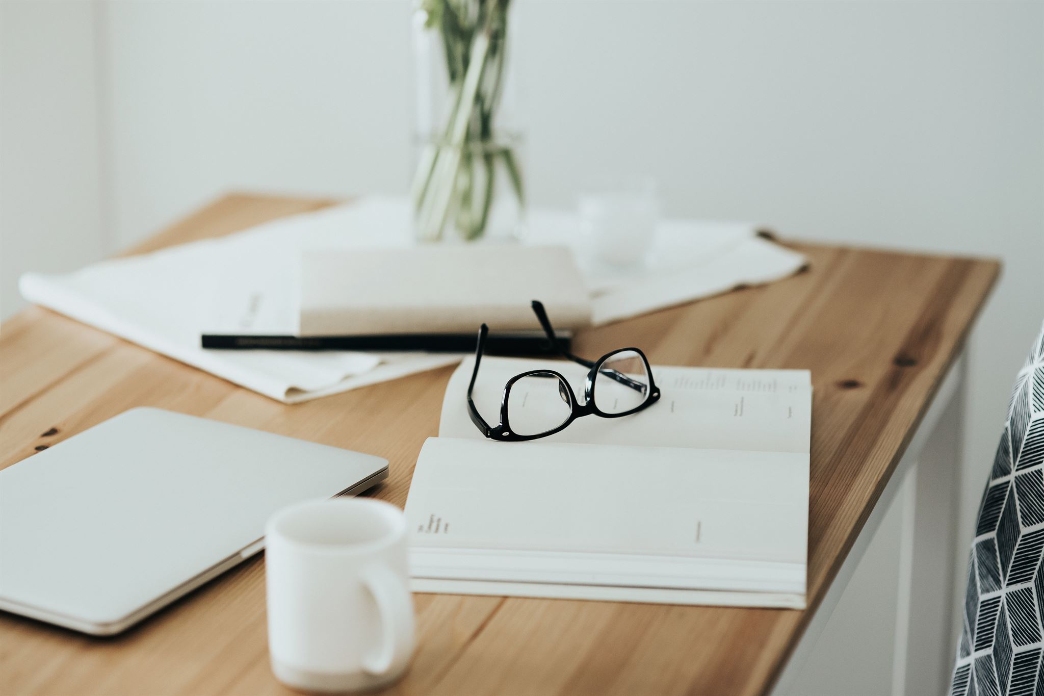 Workspace-table-with-tablet-eyeglasses-schedule-calendar-and-cup